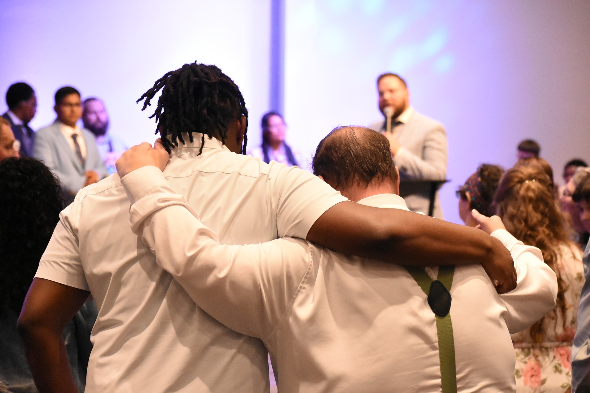 Members of Apostolic Lighthouse Church praying together during worship